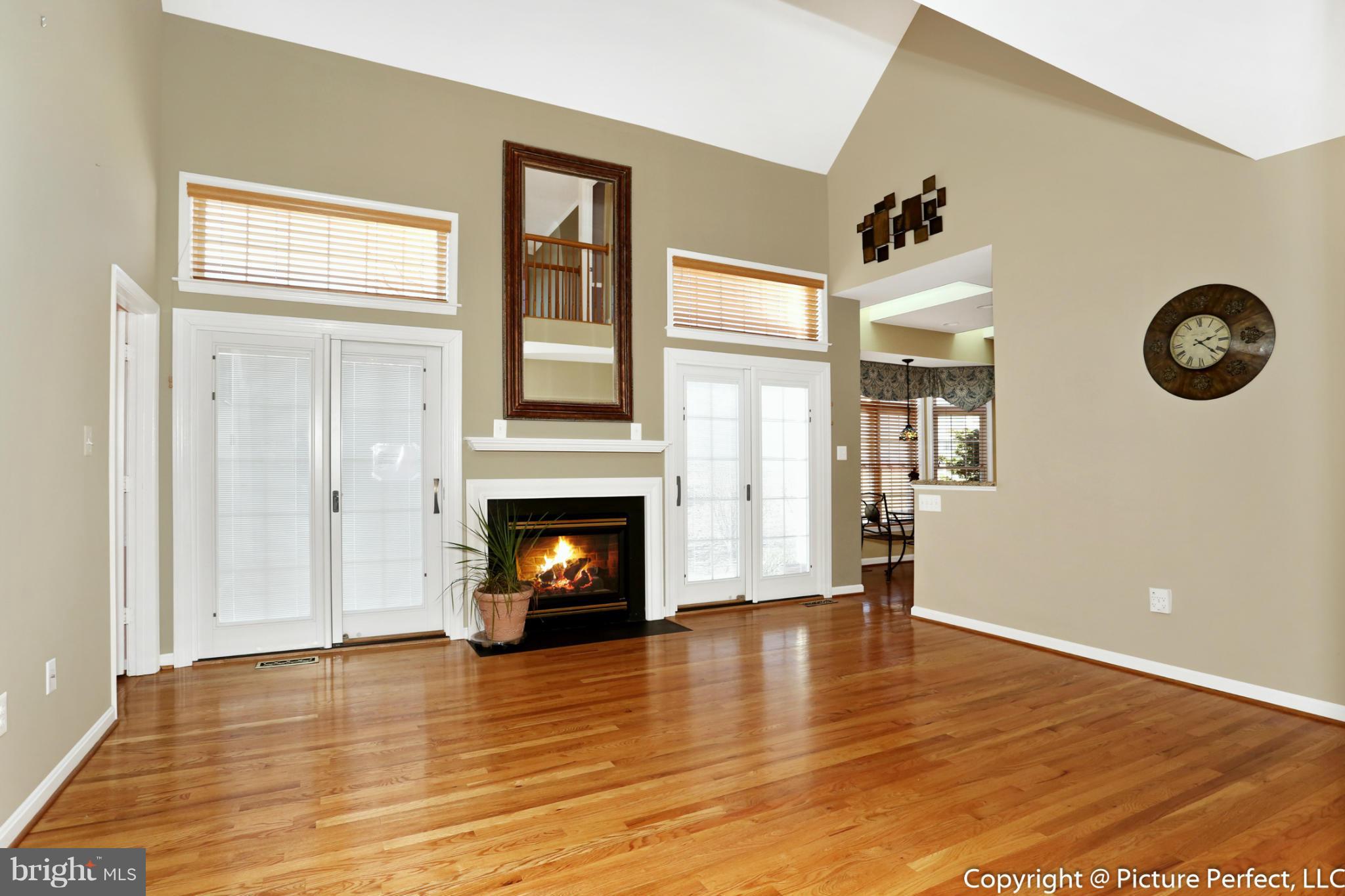2557 Bear Den Road Frederick, MD 21701 - Photo 8 of 30 a view of livingroom with a fireplace wooden floor and window