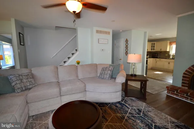 a living room with furniture and a lamp