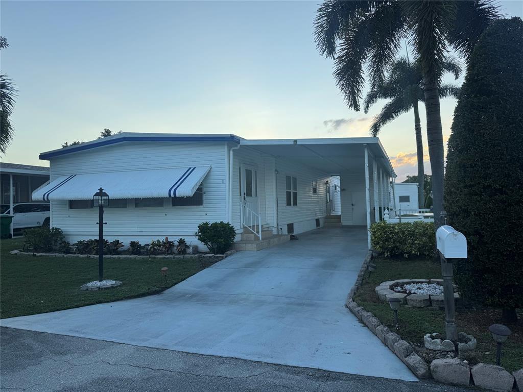 1921 Southwest 83rd Avenue Davie, FL 33324 - Photo 1 of 30 a front view of a house with garden