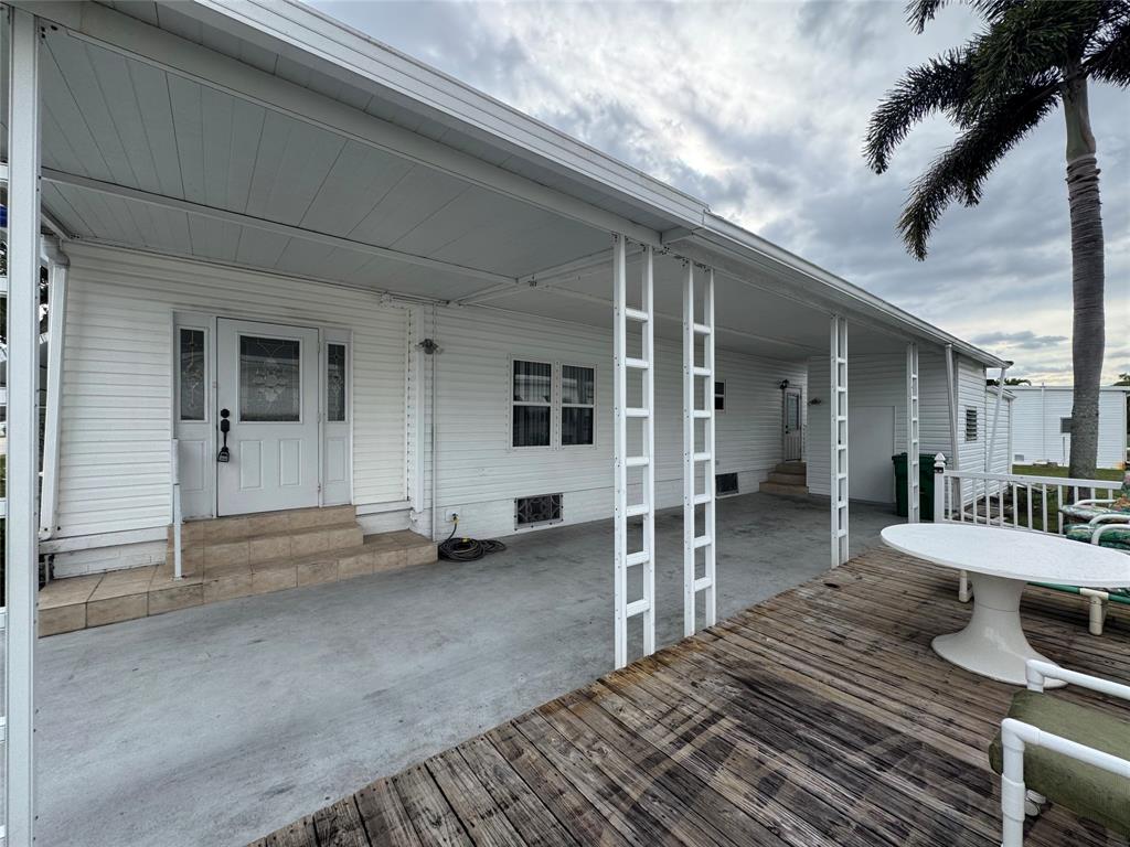 1921 Southwest 83rd Avenue Davie, FL 33324 - Photo 27 of 30 a view of a patio with table and chairs and a barbeque