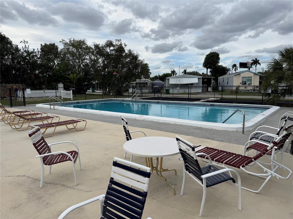 1921 Southwest 83rd Avenue Davie, FL 33324 - Photo 28 of 30 a view of a swimming pool with lounge chairs