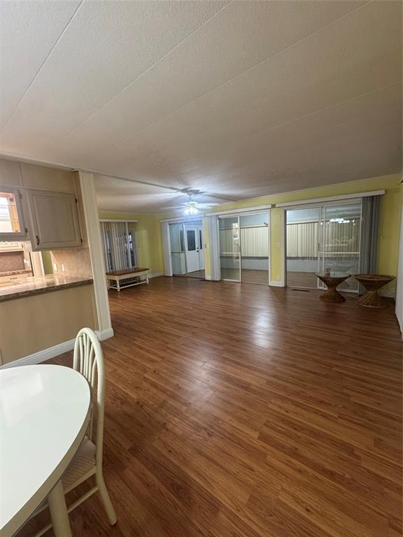 1921 Southwest 83rd Avenue Davie, FL 33324 - Photo 8 of 30 a living room with hard wood floors and a kitchen counter space