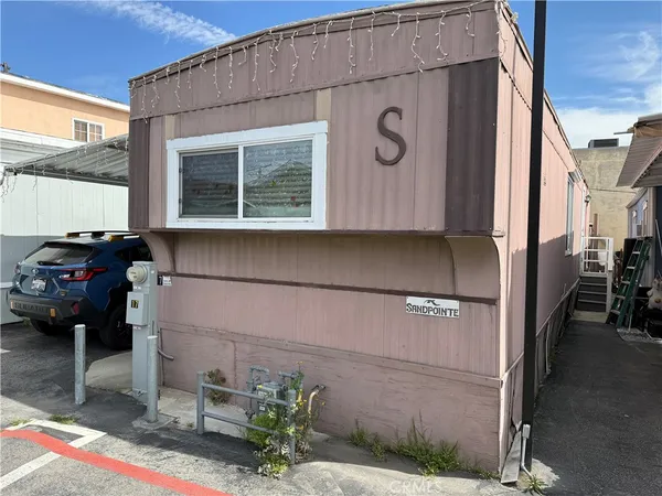 a front view of a house with parking space