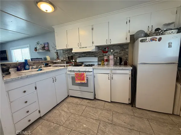a kitchen with cabinets and appliances