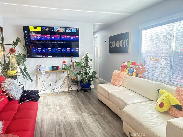 a living room with furniture toys and a window