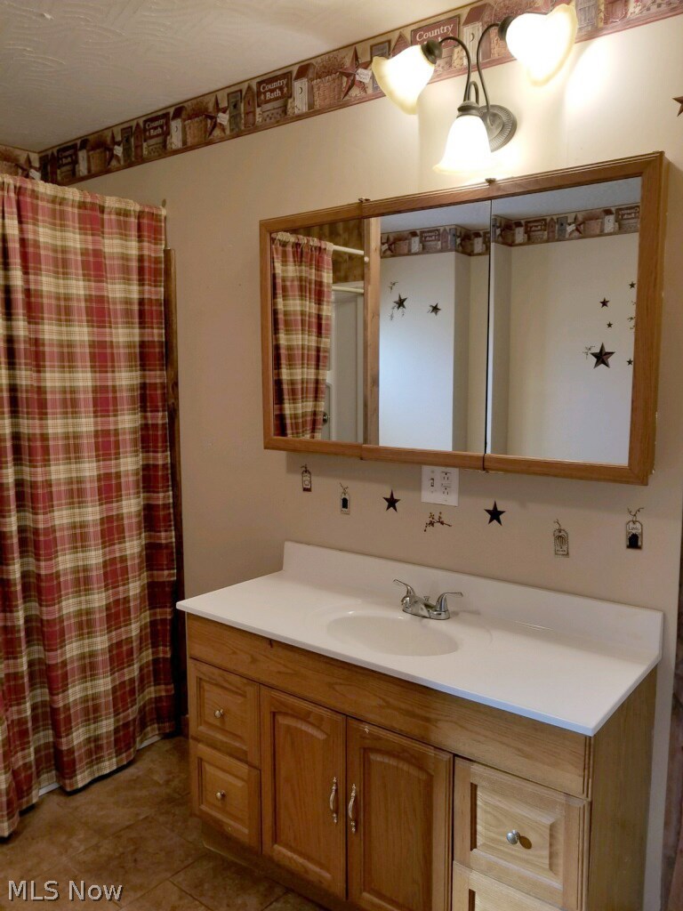 29 Fall Run Road Walker, WV 26180 - Photo 17 of 35 Full bath with cabinetry on main floor just off great room