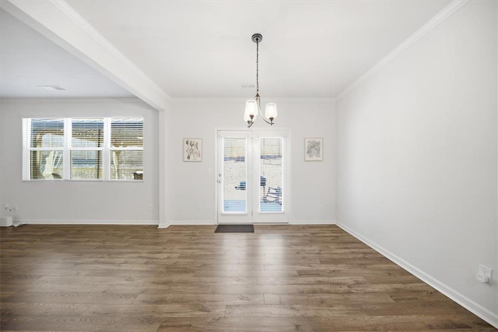 7946 Hansell Court Lithia Springs, GA 30122 - Photo 13 of 58 an empty room with wooden floor and windows