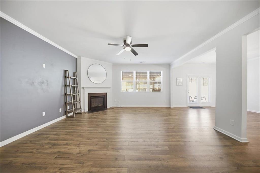 7946 Hansell Court Lithia Springs, GA 30122 - Photo 15 of 58 an empty room with windows and fireplace