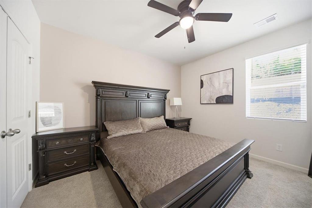 7946 Hansell Court Lithia Springs, GA 30122 - Photo 18 of 58 a bedroom with a bed and window