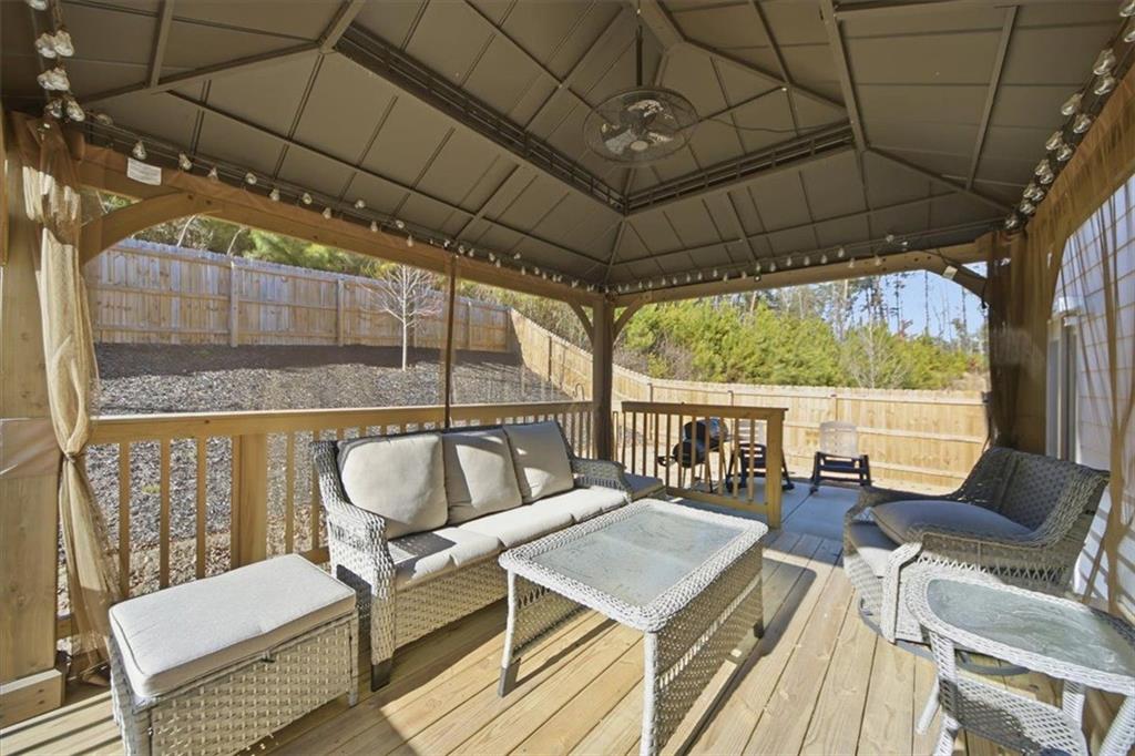 7946 Hansell Court Lithia Springs, GA 30122 - Photo 22 of 58 a outdoor living space with furniture and a rug
