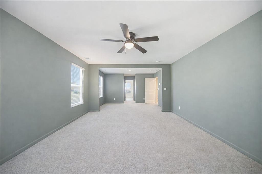 7946 Hansell Court Lithia Springs, GA 30122 - Photo 26 of 58 a view of a livingroom with a chandelier fan and windows