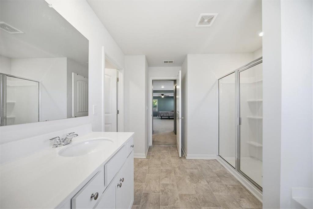 7946 Hansell Court Lithia Springs, GA 30122 - Photo 31 of 58 a bathroom with a sink and a mirror