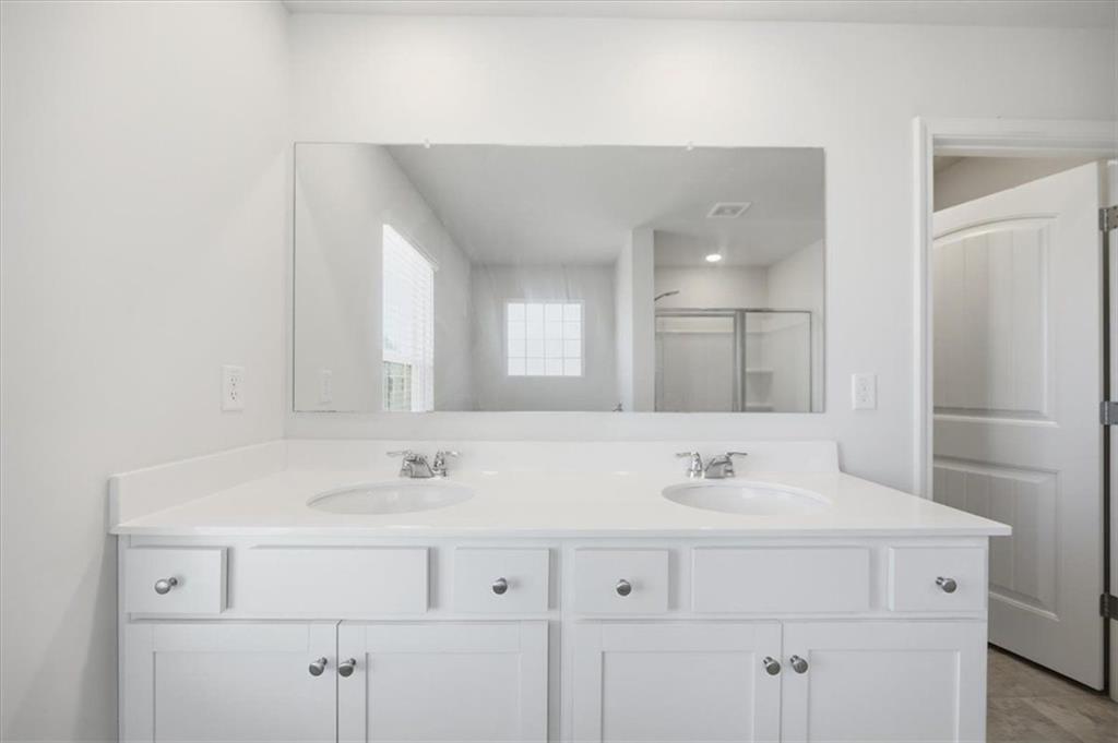 7946 Hansell Court Lithia Springs, GA 30122 - Photo 32 of 58 a bathroom with a sink and a mirror