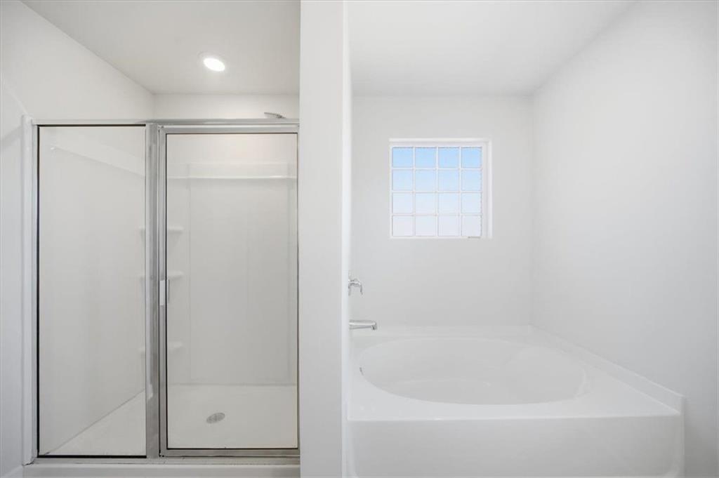 7946 Hansell Court Lithia Springs, GA 30122 - Photo 33 of 58 a white bath tub sitting next to a shower