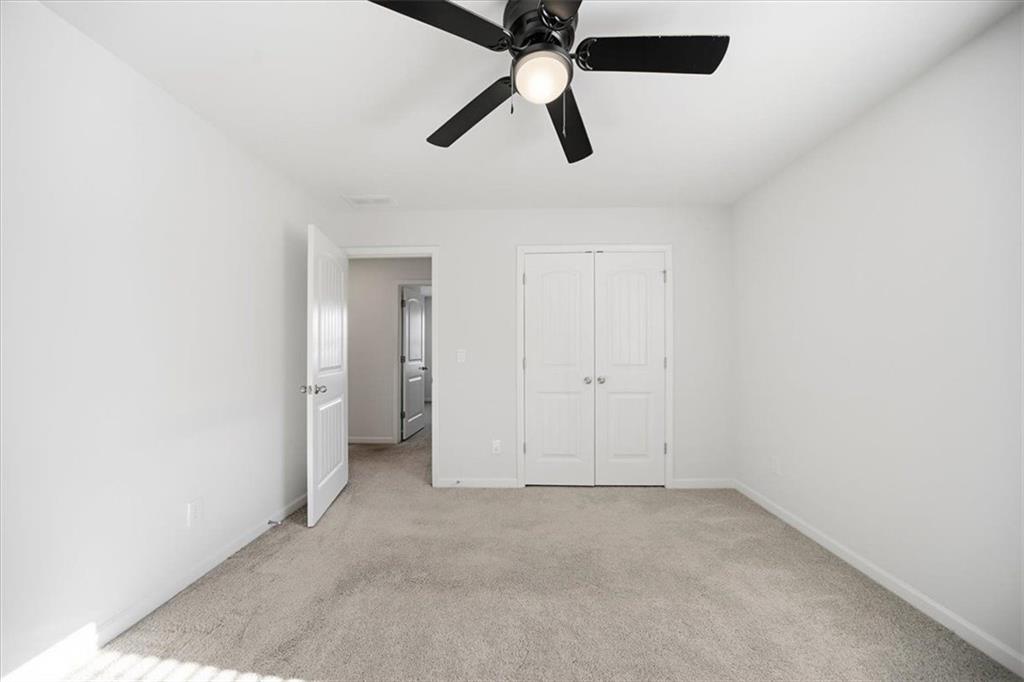 7946 Hansell Court Lithia Springs, GA 30122 - Photo 42 of 58 an empty room with ceiling fan