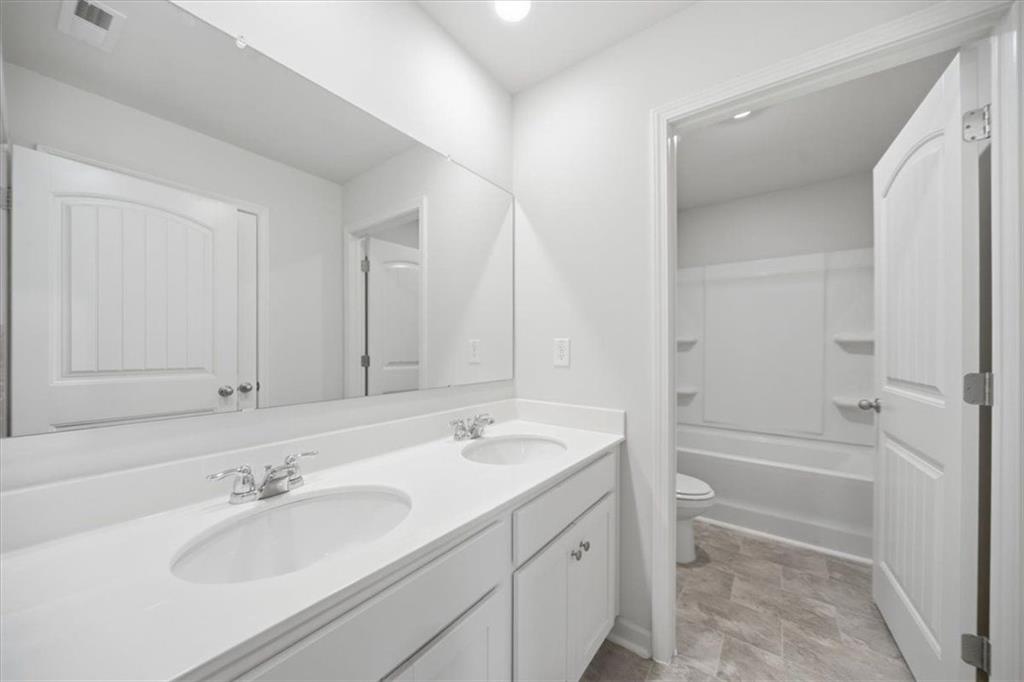 7946 Hansell Court Lithia Springs, GA 30122 - Photo 45 of 58 a bathroom with a sink and a mirror