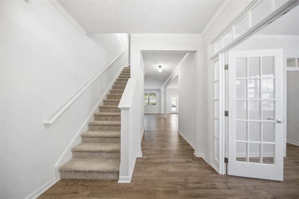 7946 Hansell Court Lithia Springs, GA 30122 - Photo 6 of 58 a view of a hallway with wooden floor and entryway