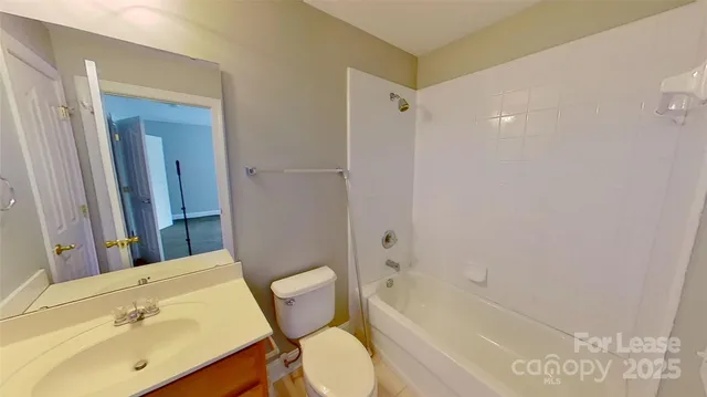 a bathroom with a sink mirror toilet and bathtub