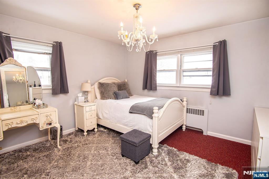 314 Valley Road Haworth, NJ 07641 - Photo 11 of 15 a living room with furniture and a chandelier
