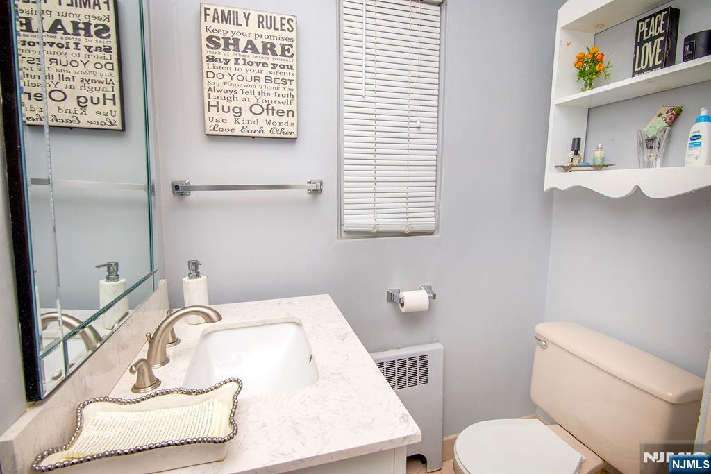 314 Valley Road Haworth, NJ 07641 - Photo 12 of 15 a bathroom with a sink toilet and a mirror