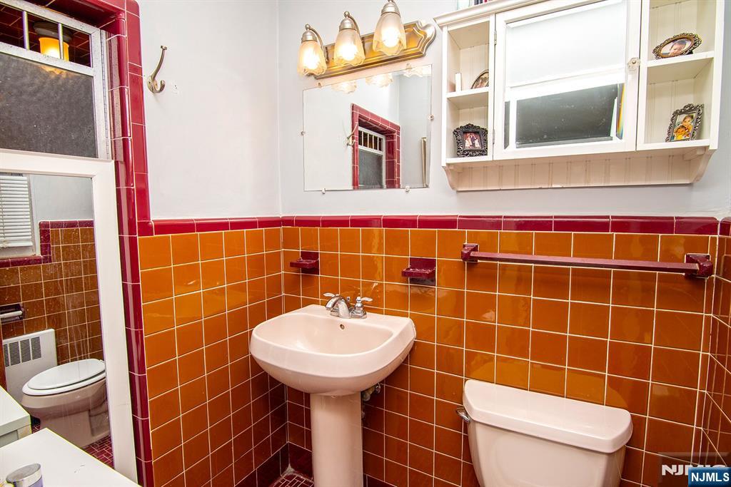 314 Valley Road Haworth, NJ 07641 - Photo 13 of 15 a bathroom with a sink toilet and mirror