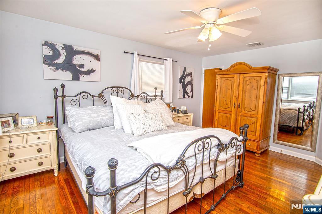 314 Valley Road Haworth, NJ 07641 - Photo 14 of 15 a bedroom with a bed and wooden floor