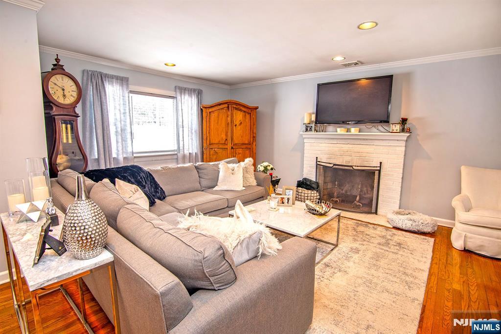 314 Valley Road Haworth, NJ 07641 - Photo 3 of 15 a living room with furniture a fireplace and a flat screen tv