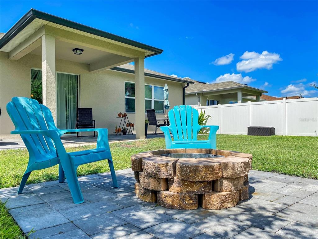 4548 Orchard Grove Road St. Cloud, FL 34772 - Photo 12 of 18 a patio with table and chairs with plants
