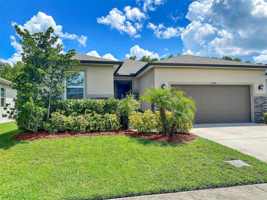 4548 Orchard Grove Road St. Cloud, FL 34772 - Photo 17 of 18 a view of a house with a garden