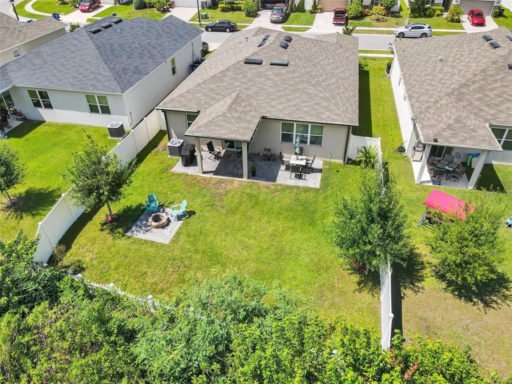 4548 Orchard Grove Road St. Cloud, FL 34772 - Photo 2 of 18 an aerial view of a house with swimming pool and large trees
