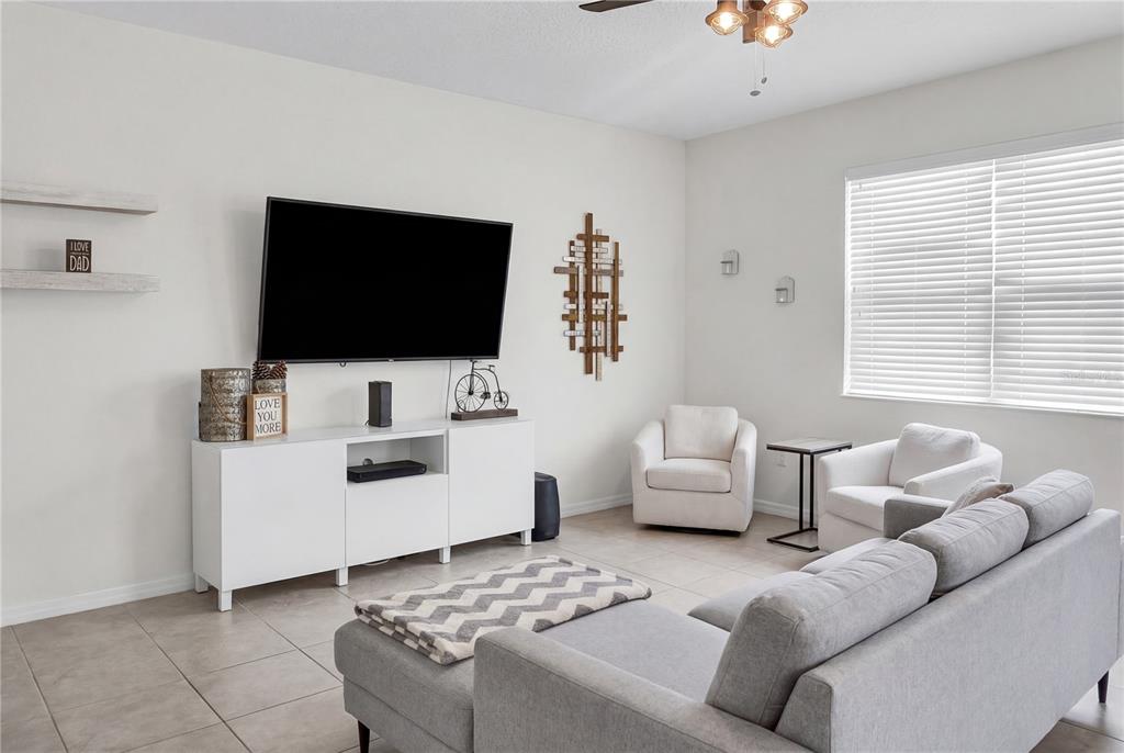 4548 Orchard Grove Road St. Cloud, FL 34772 - Photo 6 of 18 a living room with furniture and a flat screen tv