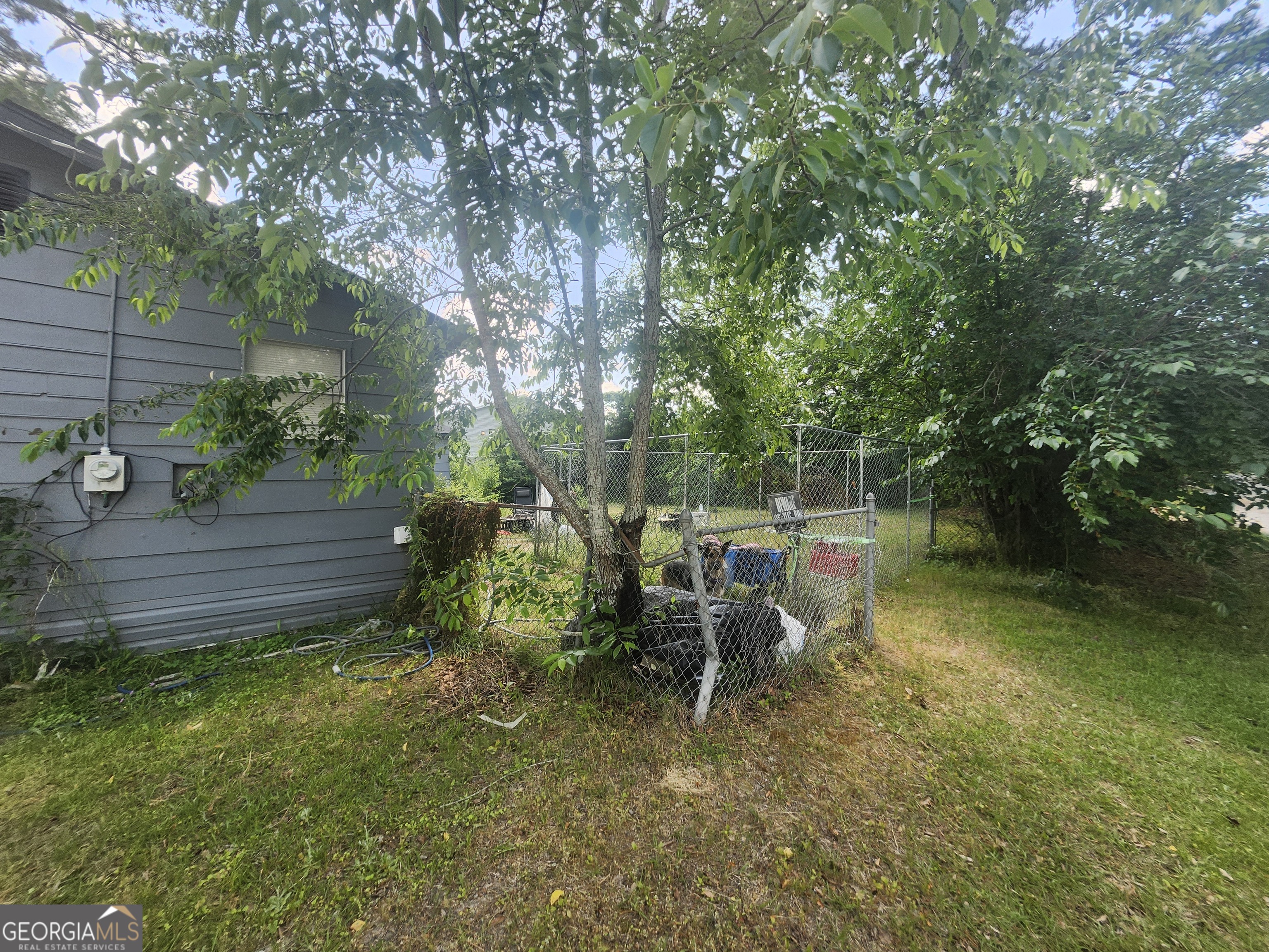 2101 South Madison Street Albany, GA 31701 - Photo 7 of 21 a wooden bench sitting in the middle of a yard