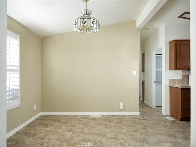 a view of an empty room with a fireplace