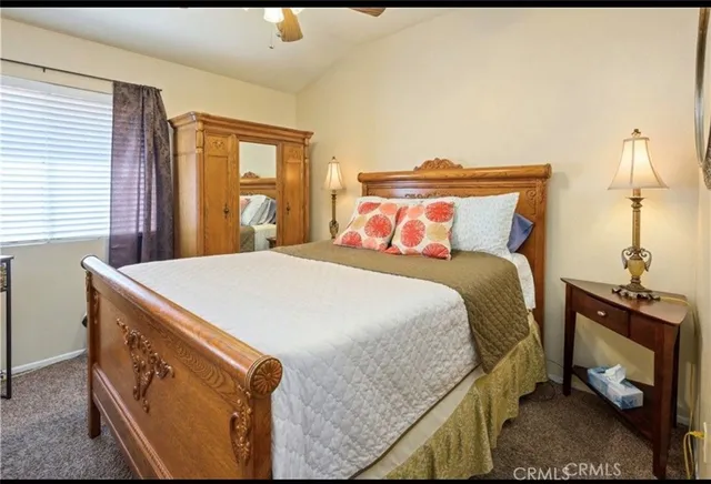 a bed sitting in a bedroom next to a window