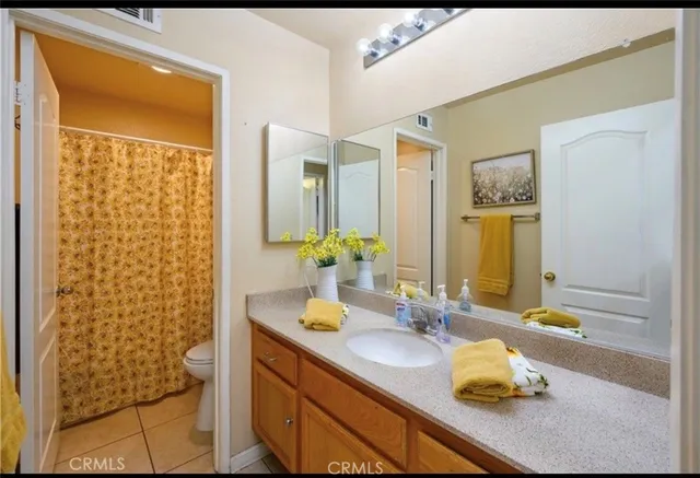a bathroom with a granite countertop sink a mirror and shower