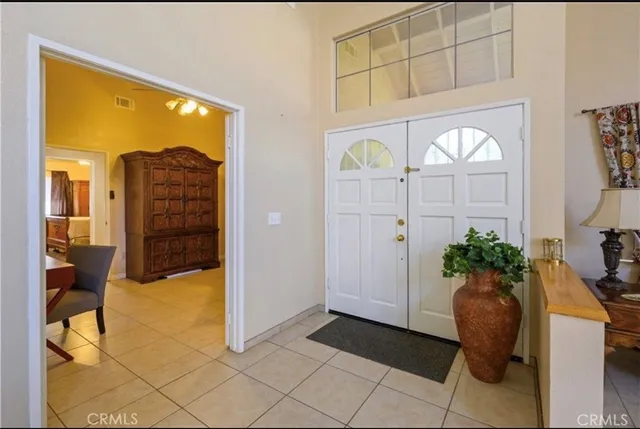 a view of entryway with wooden floor and a livingroom