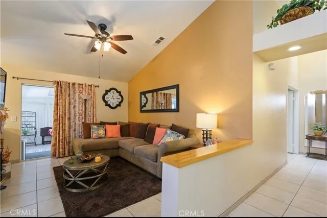 a living room with furniture and a lamp