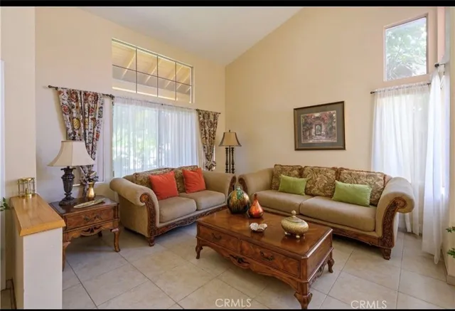 a living room with furniture a large window and a rug
