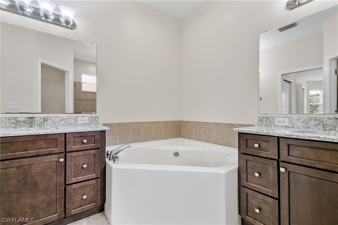 12713 Stone Tower Loop Fort Myers, FL 33913 - Photo 23 of 44 a bathroom with a bathtub sink and mirror