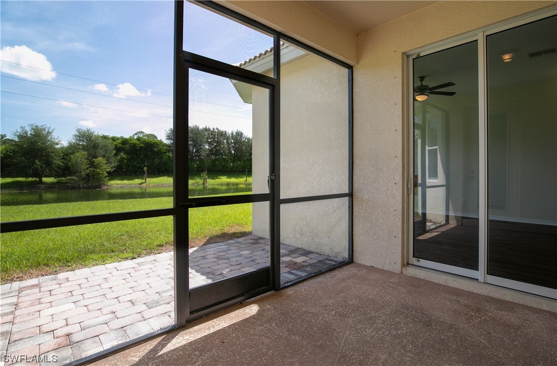 12713 Stone Tower Loop Fort Myers, FL 33913 - Photo 29 of 44 a view of a porch with a floor to ceiling window next to a yard