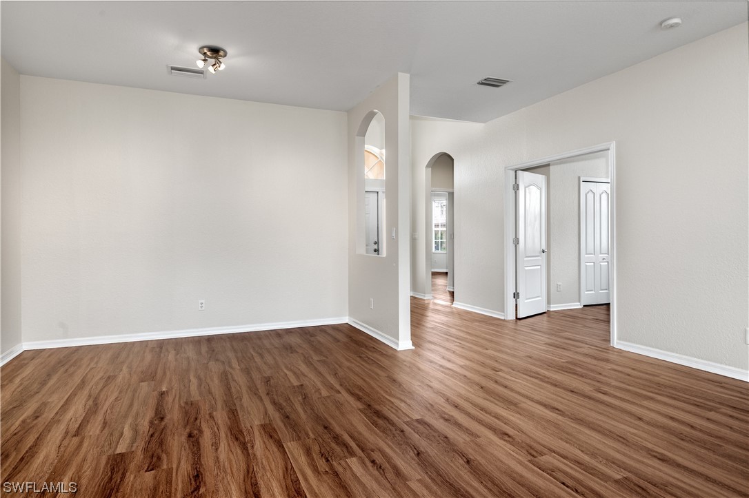 12713 Stone Tower Loop Fort Myers, FL 33913 - Photo 8 of 44 a view of an empty room with wooden floor