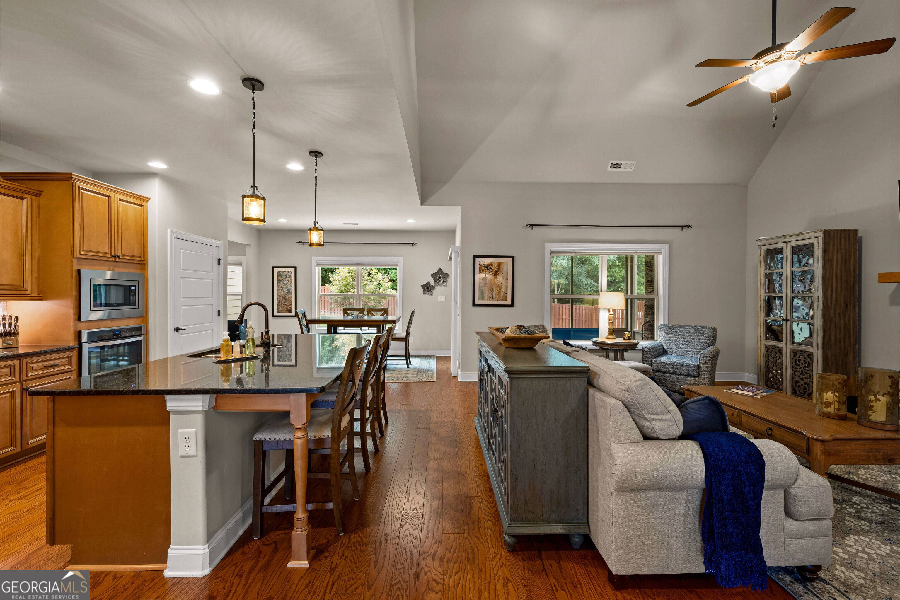 12 Delaware Way Newnan, GA 30265 - Photo 15 of 61 Open-concept living space with kitchen island view through to the stone fireplace.