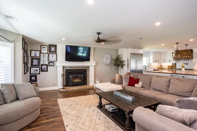 a living room with furniture a flat screen tv and a fireplace