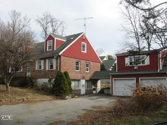406 Field Point Road Greenwich, CT 06830 - Photo 1 of 1 a front view of a house with a yard