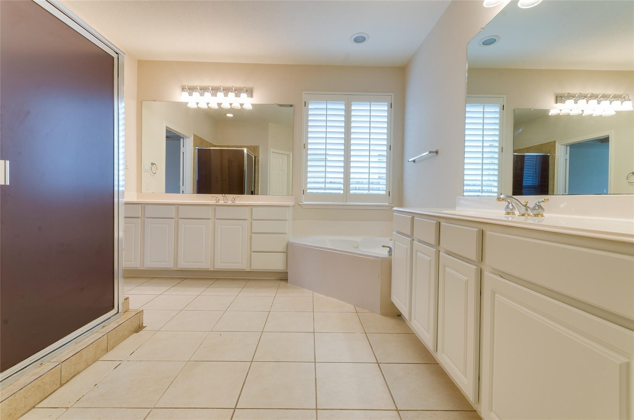 4019 Angel Spring Drive Sugar Land, TX 77479 - Photo 27 of 50 a bathroom with a sink a large mirror and a bathtub