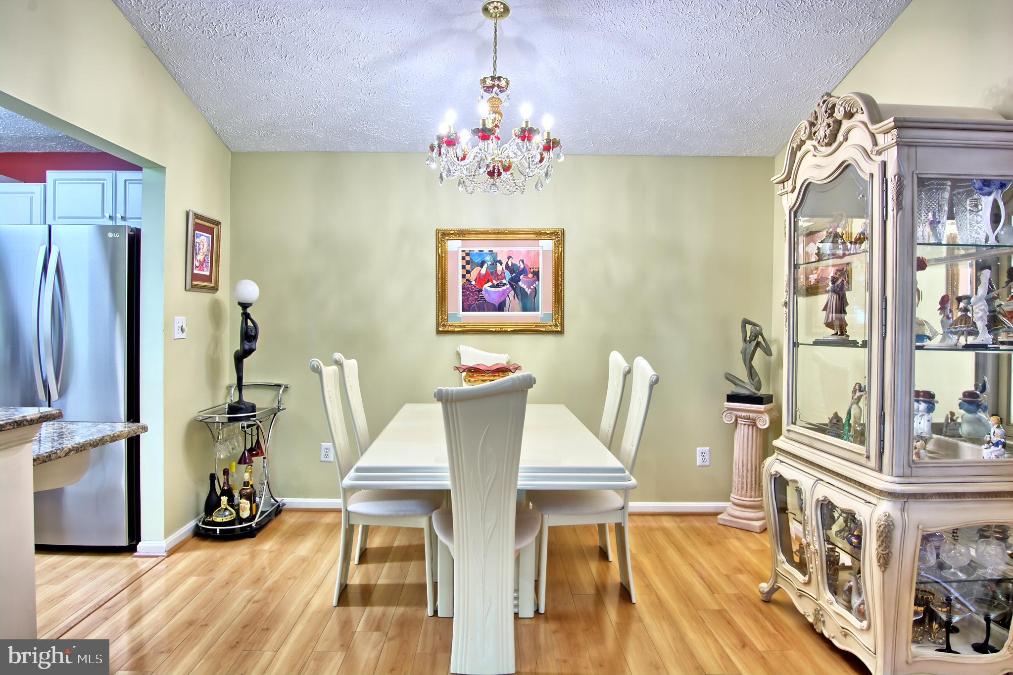 534 Kennington Road, Unit 534 Reisterstown, MD 21136 - Photo 5 of 19 a view of a dining room with furniture wooden floor and a chandelier