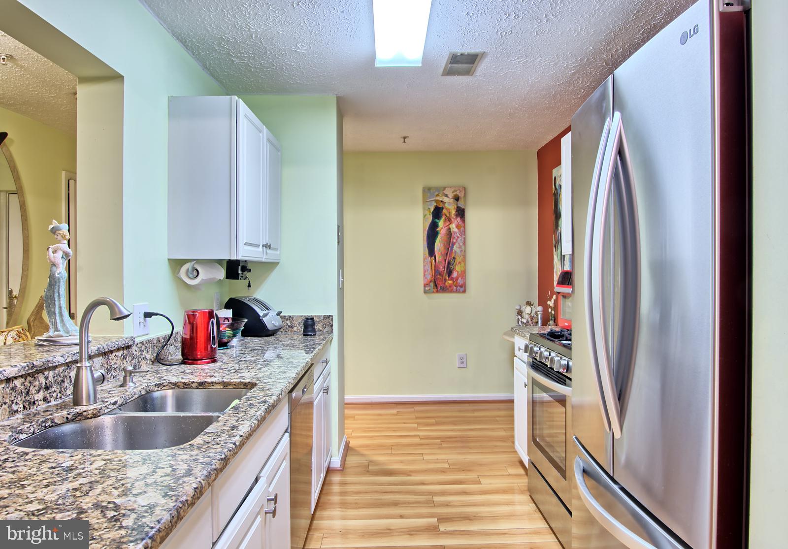 534 Kennington Road, Unit 534 Reisterstown, MD 21136 - Photo 7 of 19 a kitchen with granite countertop a refrigerator and a sink