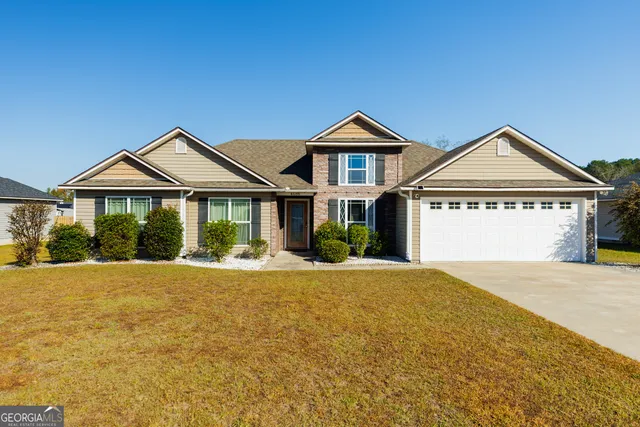 a front view of a house with a yard
