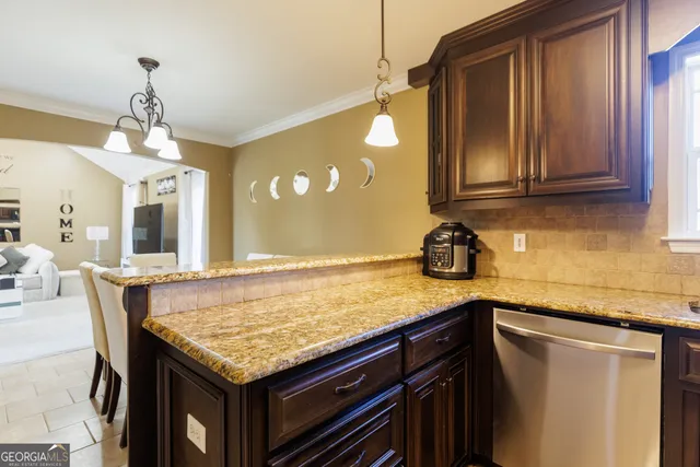 a kitchen with granite countertop wood cabinets and a sink