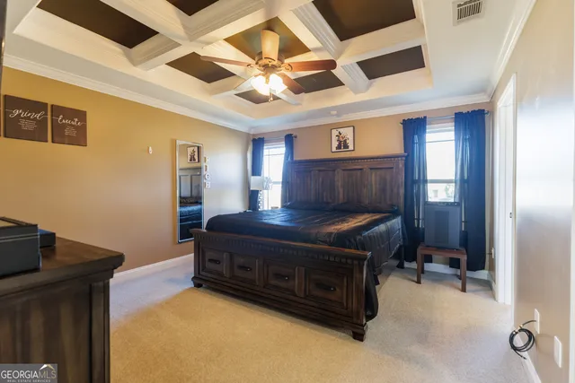 a living room with a bed furniture and a flat screen tv